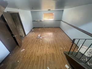 Spare room featuring wood-type flooring