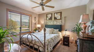 Bedroom featuring carpet flooring, baseboards, and ceiling fan