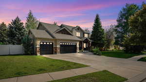 Craftsman-style house featuring driveway, stone siding, a garage, stucco siding, and a shingled roof