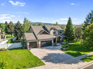 Craftsman house featuring a garage, stone siding, concrete driveway, a porch, and a shingled roof