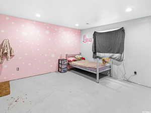 Bedroom featuring concrete floors and recessed lighting