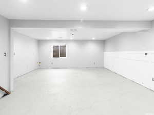 Finished basement featuring recessed lighting