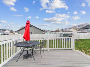 Wooden deck featuring outdoor dining space and a residential view
