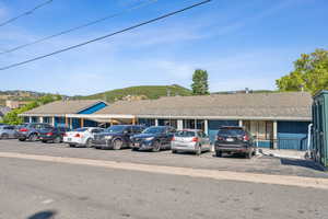 View of front of house with uncovered parking and a mountain view