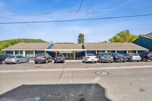 View of building exterior with uncovered parking