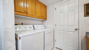 Laundry area with washing machine and clothes dryer and cabinet space