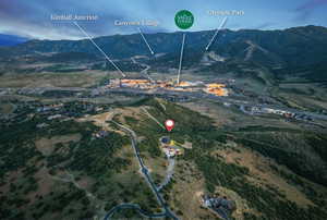 Aerial view of property and surrounding area featuring mountains