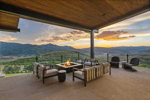 View of patio / terrace with a mountain view and a fire pit