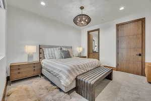 Bedroom with carpet floors, recessed lighting, connected bathroom, and a wall mounted AC