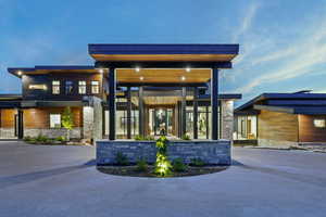 Rear view of property with stone siding