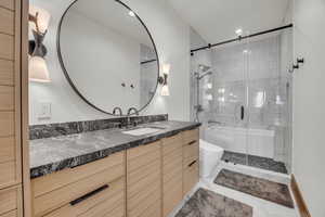 Full bathroom featuring vanity, recessed lighting, and combined bath / shower with glass door