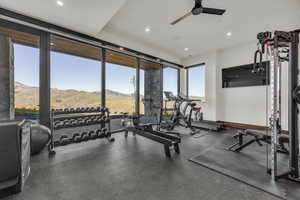 Gym with recessed lighting, a ceiling fan, and expansive windows