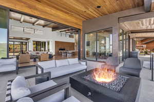 View of patio with an outdoor living space with a fire pit
