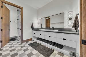 Bathroom with vanity, a stall shower, and light flooring