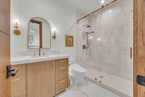 Full bath with vanity, a stall shower, and recessed lighting