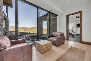 Living area with wood finished floors, a ceiling fan, and recessed lighting