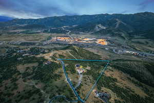 Aerial overview of property's location with property parcel outlined and mountains
