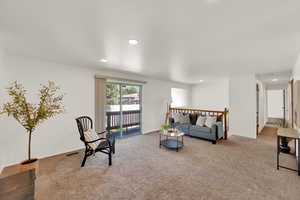 Carpeted living area featuring recessed lighting