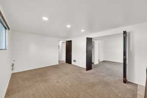 Carpeted spare room with recessed lighting