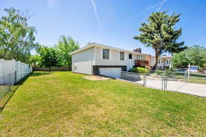 View of yard featuring driveway and an attached garage