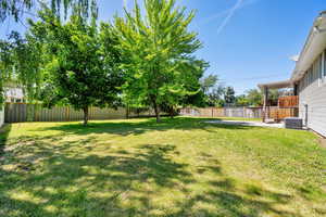 View of yard featuring central air condition unit and a patio