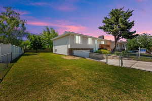 View of front of property featuring concrete driveway, a garage, and a chimney
