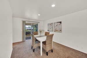 Dining space with light colored carpet, recessed lighting, and baseboards
