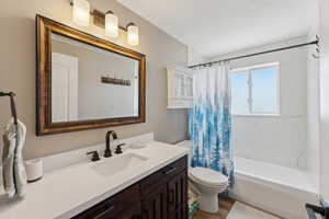 Full bathroom featuring vanity, toilet, shower / tub combo, and wood finished floors