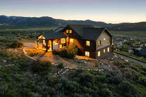View of front of house featuring a mountain view and a shingled roof