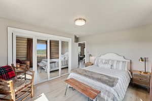 Bedroom featuring light wood finished floors and access to outside