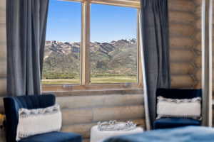 Sitting room featuring healthy amount of natural light, log walls, and a mountain view