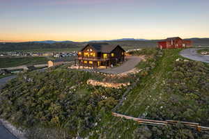 Rear view of house featuring a deck with mountain view and an outbuilding