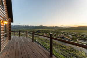 Deck at dusk featuring a mountain view