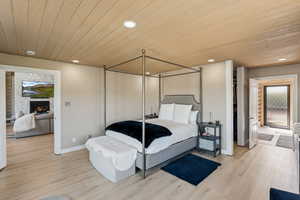Bedroom featuring wood ceiling, multiple windows, recessed lighting, light wood-style flooring, and baseboards