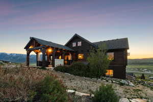 Log-style house featuring log exterior and roof with shingles