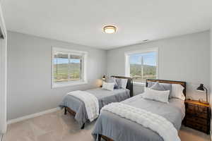 Carpeted bedroom featuring baseboards