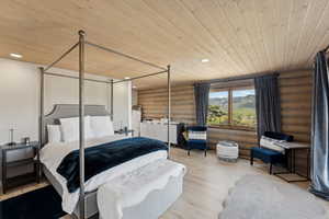 Bedroom with rustic walls, wooden ceiling, recessed lighting, and wood finished floors