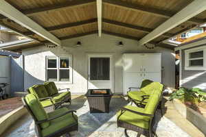 View of patio with an outdoor living space with a fire pit