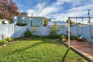 View of yard with a patio and a gate