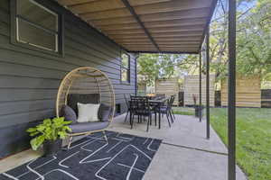 View of patio featuring outdoor dining space and privacy panels.