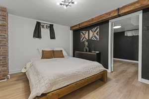 Bedroom featuring wood finished floors and baseboards