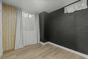 Empty room featuring light wood-style floors and baseboards