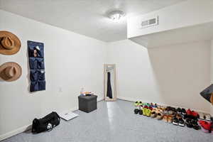 Rec room with baseboards and speckled floor