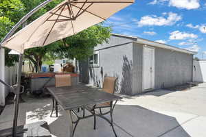 View of patio / terrace with a hot tub and outdoor dining space