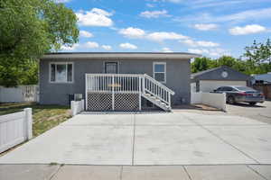 View of front of property with stucco siding, an outdoor structure, and central air condition unit