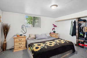 Bedroom with speckled floor and a textured ceiling