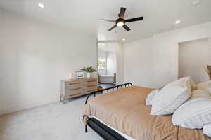 Bedroom with light carpet, recessed lighting, baseboards, and a ceiling fan