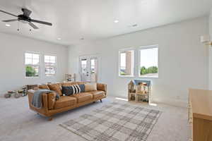 Living room with carpet, recessed lighting, baseboards, and a ceiling fan
