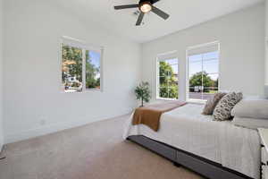 Carpeted bedroom with baseboards and a ceiling fan