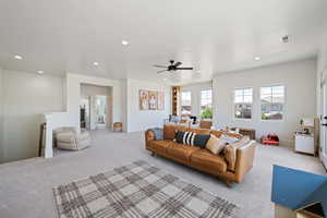 Living area with light carpet, recessed lighting, and ceiling fan